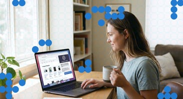 A woman sits in front of a computer scrolling a product listing page.