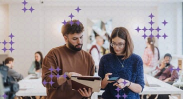 Two people discuss information in an office setting.