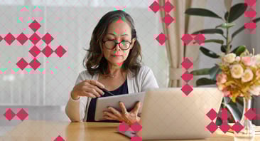 A woman scrolls on a tablet.