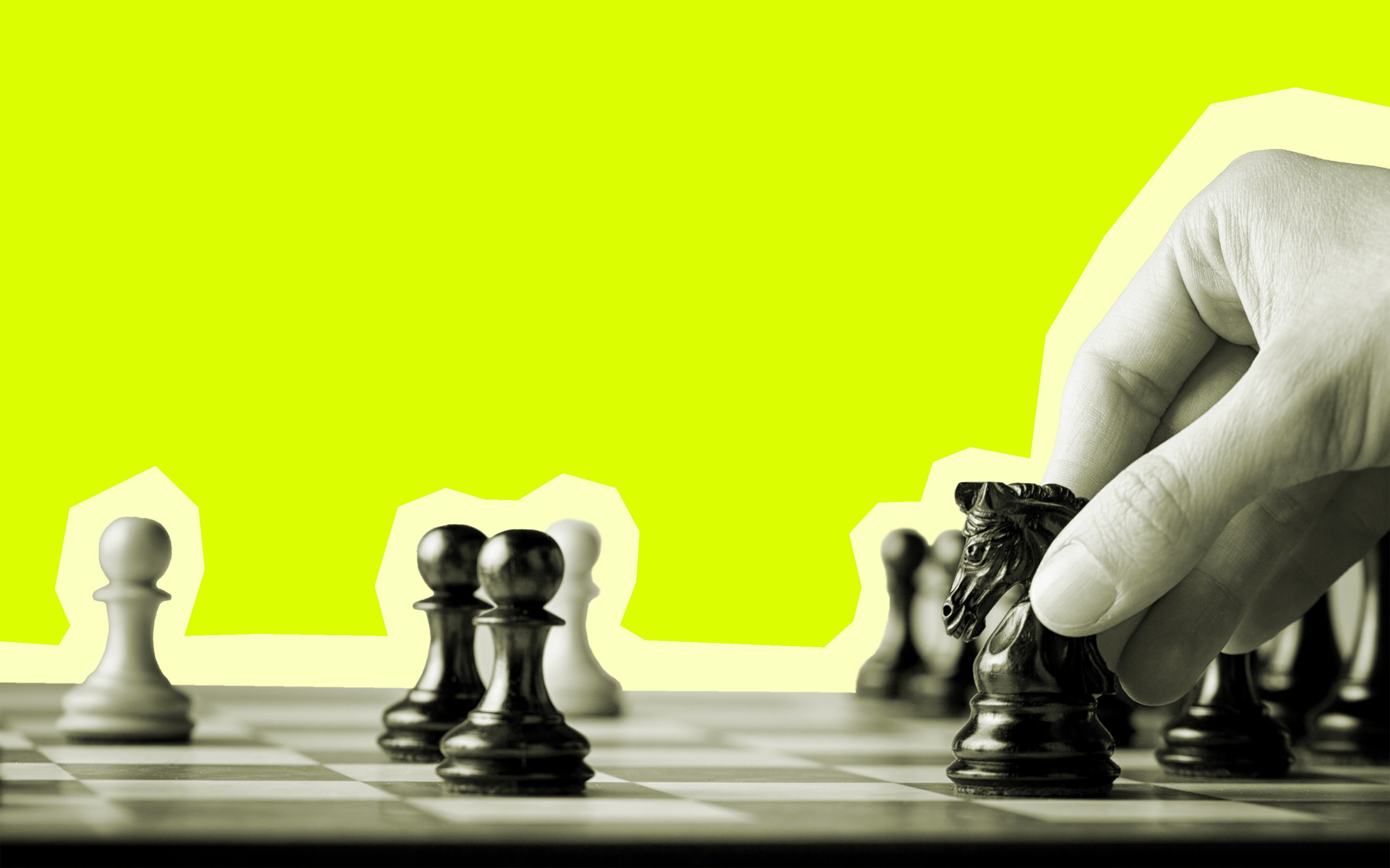  A cut out image of a hand moving the black knight chess piece on a chess board to represent strategic advancement.